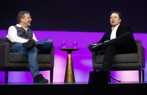 Photo: Elon Musk speaking at podium - illustrating article 'Acquisition of Twitter by Elon Musk'