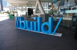 Microsoft Puts AI Agents at Center of Copilot Expansion Microsoft Build conference stage with Copilot AI agent interface displayed on large screens