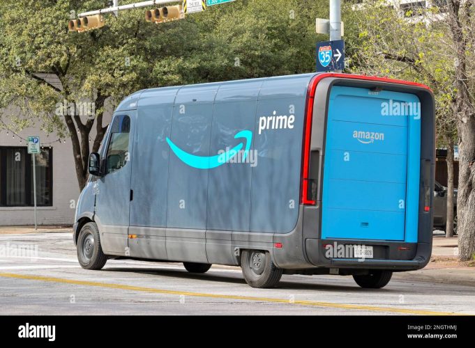 Amazon Prime Delivery Van Amazon warehouse worker sorts boxes labeled essential items during coronavirus lockdown