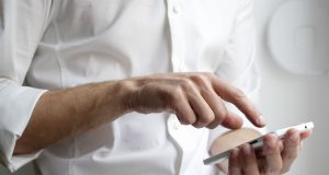 Apple Pays $500M to Settle iPhone Slowdown Claims A courtroom gavel and legal documents on a desk near an iPhone 6 and 7, symbolizing the settlement over performance throttling.