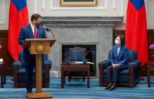 Arizona Governor Doug Ducey shakes hands with Taiwanese President Tsai Ing-wen in a Taipei meeting room, with flags of both entities in the background.