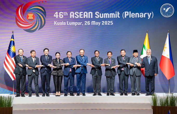 Malaysian officials welcome ASEAN leaders beneath flags at Kuala Lumpur convention centre on 26 May 2025.
