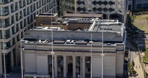 Bank of England Probes Climate Risks to UK Finance Bank of England building exterior with financial district skyline in background under overcast sky