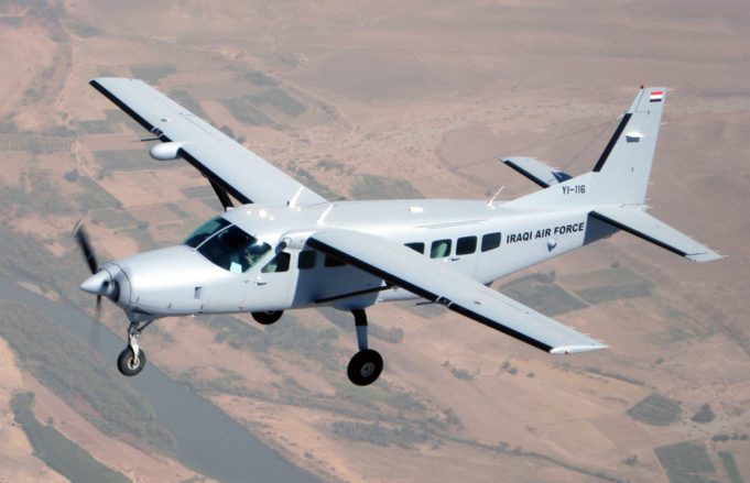 Cessna 208 Caravan Crashes in Indonesia's Highland Papua Region Rescue workers in rain gear navigate muddy terrain near a crashed Cessna 208 Caravan in a remote Indonesian highland region.