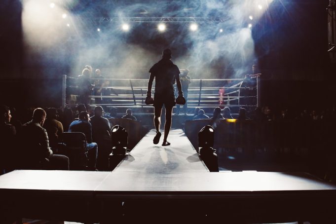 Lauren Price Unifies Welterweight Division with Five Titles in One Fight Lauren Price in a boxing ring wearing championship belts after unifying the welterweight division.