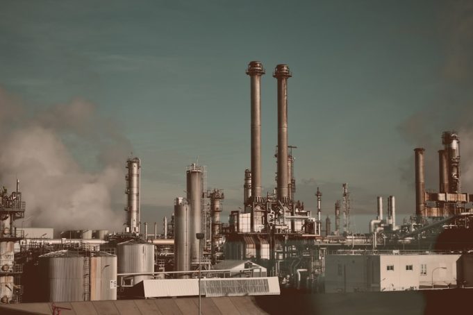 OPEC Controls Nearly 80 Percent of Global Oil Reserves An OPEC flag flies above an oil drilling rig in a desert landscape, symbolizing the cartel's control over global crude supplies.