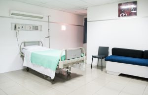 A medical professional preparing a slow intravenous injection of pembrolizumab in a clinical setting.