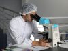 A Cologuard test kit box sits on a table, representing the at-home colorectal cancer screening product central to Abbott's acquisition of Exact Sciences.