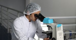 Abbott Buys Exact Sciences in $21B Cancer Deal A Cologuard test kit box sits on a table, representing the at-home colorectal cancer screening product central to Abbott's acquisition of Exact Sciences.