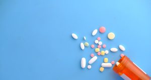 FDA Approves Zurzuvae Pill for Postpartum Depression A new mother holds her infant while reading the Zurzuvae prescription bottle, symbolizing the first pill approved for postpartum depression.