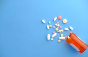 FDA Approves Zurzuvae Pill for Postpartum Depression A new mother holds her infant while reading the Zurzuvae prescription bottle, symbolizing the first pill approved for postpartum depression.
