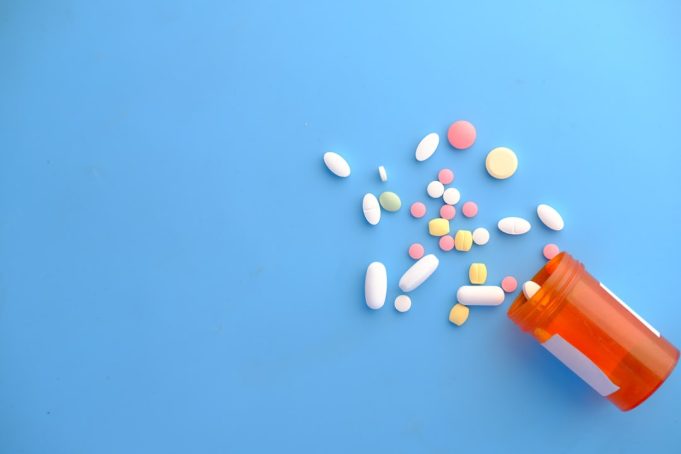 FDA Approves Zuranolone as First Pill for Postpartum Depression A new mother holds her infant while reading the Zurzuvae prescription bottle, symbolizing the first pill approved for postpartum depression.