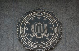FBI Releases 62-HQ-83894 UFO Case File A redacted FBI document titled 62-HQ-83894 with blacked-out text and official stamps on a desk.