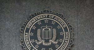 FBI Releases Unidentified UAP Image to Pentagon Archive A grainy black-and-white image shows a small dark circular object in a crosshair reticle against a mountain range, labeled as FBI evidence submitted to the Pentagon.