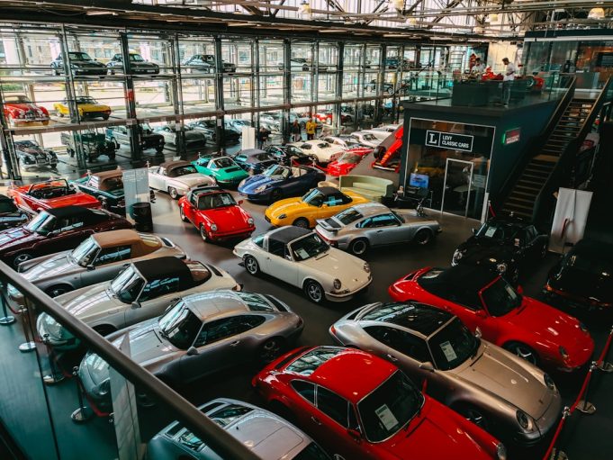 MG ZS Reaches Nearly One Million Global Sales by December 2023 White MG ZS crossover parked at a charging station with city skyline behind, highlighting the model’s global electric and petrol success.