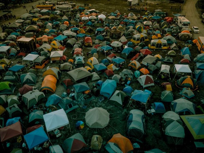 Ethnic Armenian refugees crowd a road as they flee Nagorno-Karabakh in September 2023, carrying belongings and children.