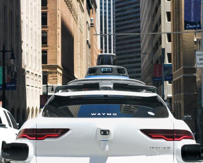 Waymo's 3,700 robotaxis now complete 500,000 paid rides weekly across ten cities A Waymo autonomous vehicle drives through a city street with no driver behind the wheel during a paid passenger ride.