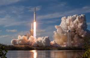 SpaceX Hits 55% Starship Success Rate, Eyes Rapid Reuse Starship Super Heavy booster fires methane-oxygen Raptors during vertical touchdown beside the launch tower.