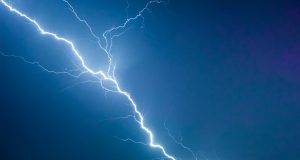 Dark storm clouds loom over Yemen’s rugged hills as lightning forks toward the ground where villagers stand in open fields.