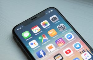 Kyrgyzstan Bans TikTok to Protect Children’s Health A teenager in Bishkek scrolling through TikTok on a smartphone, with the Tian Shan mountains visible in the background.