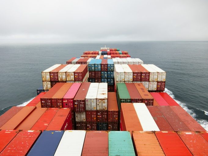 Russian Strike on Iron Ore Ship to China Raises Questions on Beijing's Stance A damaged cargo ship with a Liberian flag sits in a Ukrainian port after a missile strike, with smoke rising from the deck.