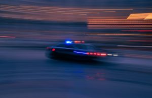 Police lights flash near a cordoned-off street in Rockford, Illinois, after a stabbing spree left four dead and seven wounded.