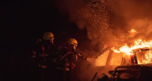 Flames and smoke rise above the cramped wooden stalls of Manama Souq as firefighters work in narrow alleys after the June 2024 blaze.