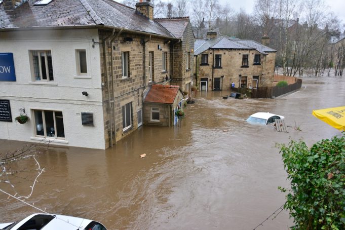 Vienna Faces Extensive Cleanup and Economic Loss After Record Rainfall Flooding Floodwaters cover a Vienna street as residents wade through debris near damaged buildings.