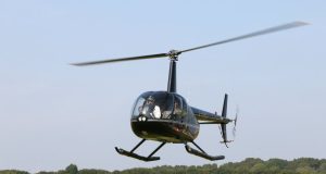5 Ugandan Soldiers Killed in Mogadishu Helicopter Crash Wreckage of a military helicopter near an airport runway in Mogadishu, with emergency responders approaching the crash site.