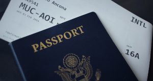 EU Ends Multiple-Entry Visas for Russians, Exempts Dissidents European Union flag flying outside a Schengen zone border checkpoint with travelers queuing nearby