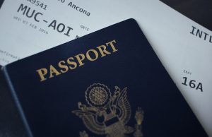 EU Ends Multiple-Entry Visas for Russians, Exempts Dissidents European Union flag flying outside a Schengen zone border checkpoint with travelers queuing nearby