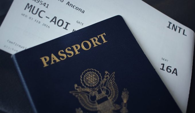 EU Visa Restrictions for Russians Include Exemptions for Dissidents and Journalists European Union flag flying outside a Schengen zone border checkpoint with travelers queuing nearby