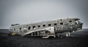 Agape Flights Crash Kills Two Pilots in Haiti Wreckage of an Embraer EMB 110 Bandeirante cargo plane scattered on a remote Haitian airstrip surrounded by mountains.