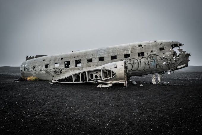 Agape Flights Crash in Haiti Severs Critical Supply Route for Two Pilots Wreckage of an Embraer EMB 110 Bandeirante cargo plane scattered on a remote Haitian airstrip surrounded by mountains.