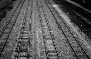 Seven Suspected Immigrants Die in Texas Train Boxcar A sealed train boxcar sits on tracks in a Texas rail yard, surrounded by emergency vehicles and investigators.