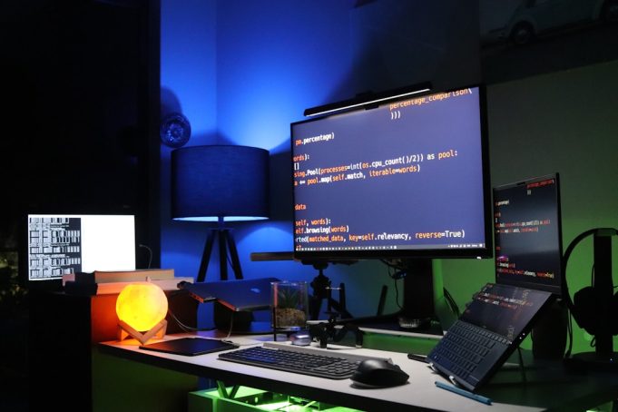 A developer examines a high-resolution AI-generated image on a computer screen, with code visible in the background.