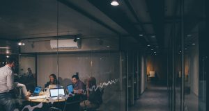 Anthropic Raises $13B in Record AI Funding Round Anthropic co-founders Daniela and Dario Amodei stand in a modern office, discussing AI safety on a screen displaying Claude's constitutional AI principles.
