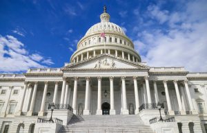 Shmyhal Warns Stalled US Aid Risks Wider War Ukrainian Prime Minister Denys Shmyhal speaks at a podium, warning of wider war if US Congress fails to approve aid package.