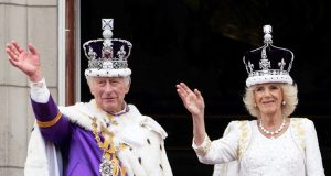 Charles III Crowned King in Historic Coronation Charles III and Camilla sit enthroned in Westminster Abbey during their coronation ceremony, surrounded by clergy and royal family members.