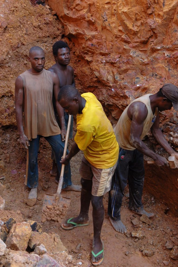 Rescuers gather near a flooded gold mine tunnel entrance in Kangaba, Mali, after a reservoir spill trapped miners underground.