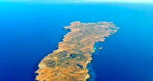 26 Migrants Die as Boat Capsizes Off Lampedusa Rescue boats search near a capsized migrant vessel off the coast of Lampedusa, with emergency crews in the Mediterranean Sea.
