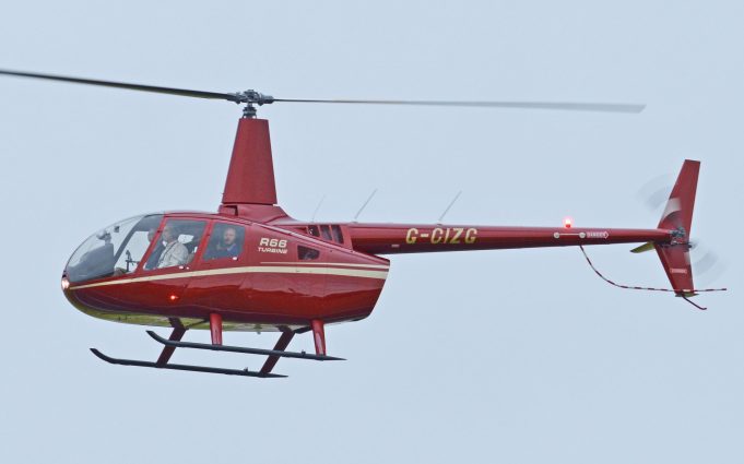 Helicopter Crash in Montana Kills Four People Near Ekalaka Smoldering wreckage of a red-and-white Robinson R66 helicopter lies in a Montana pasture as investigators examine the scene under overcast skies.