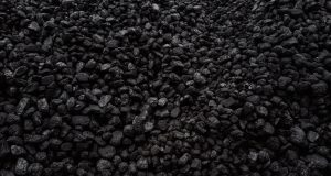 EU Bans Russian Coal, Costs Moscow €4B Yearly European Union officials signing documents on a coal embargo against Russia, with charts showing energy trade figures in the background.