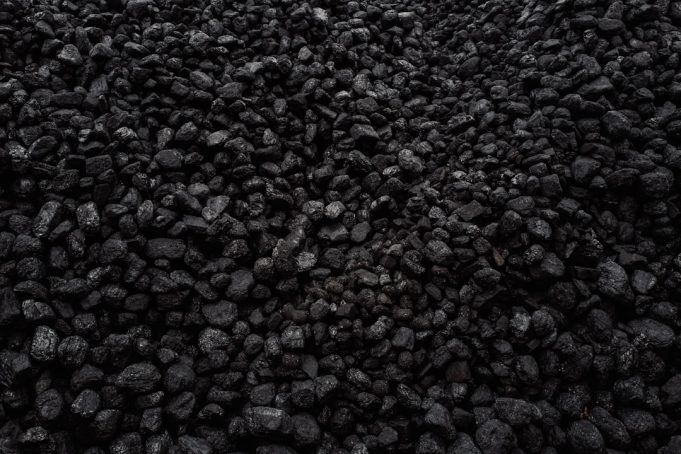 EU's Russian coal ban costs Moscow €4 billion yearly, but energy reliance persists European Union officials signing documents on a coal embargo against Russia, with charts showing energy trade figures in the background.