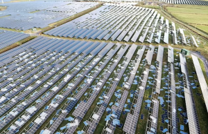 UK Solar Hits Record 15,420 Megawatts Output Solar panels on a rooftop in the UK under bright sunlight, generating electricity for the grid.