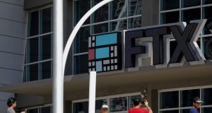 FTX Collapse Exposes $8 Billion Hole in Accounts A computer screen displays the FTX exchange website with a bankruptcy notice, reflecting the company's financial collapse in November 2022.