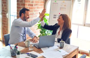 Google Offers $340M Ad Credits to Small Businesses A small business owner stands in a closed storefront, looking at a laptop showing Google Ads dashboard, reflecting pandemic economic impact.