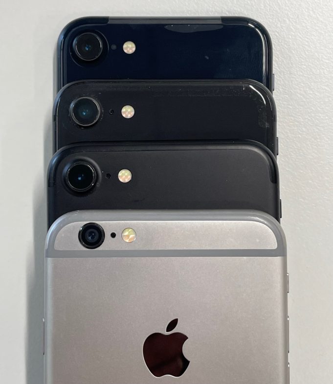 IPhone 15 Apple CEO holds new iPhone 15 on stage, USB-C port visible under studio lights at Apple Park event.