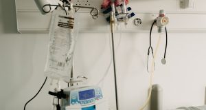 Philippines Unlocks Emergency Funds as COVID-19 Hits 33 Manila residents wearing face masks walk past a health advisory board listing COVID-19 cases in the capital city.