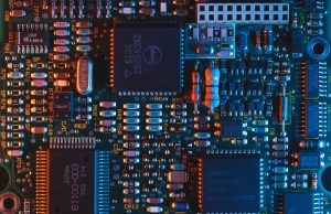 Assembly line stands idle while empty chip reels highlight the semiconductor shortage delaying Reliance and Google’s budget phone.